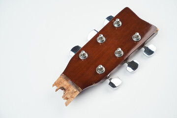 Broken guitar neck on a white background with copy space