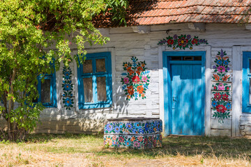 Fototapeta na wymiar Traditionally painted houses with floral motifs. The Colorful Village of Zalipie in the Lesser Poland Voivodeship. Poland. August 2020