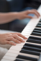Fototapeta na wymiar close up of kid hands playing piano