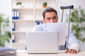 Injured male employee at workplace after accident