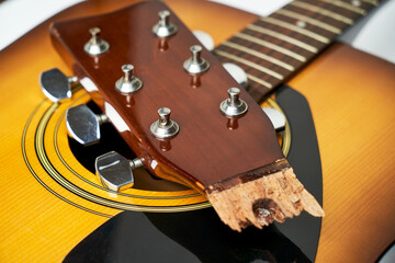 Broken guitar neck on a white background with copy space