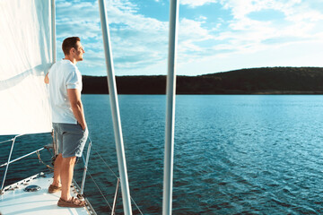 Guy Standing On Yacht Deck Enjoying Sea Breeze Outdoor