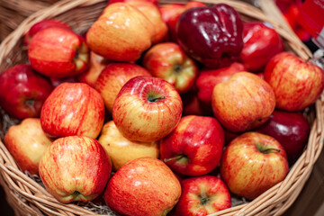 Basket of red ripe apples. Organic natural apples in wooden basket.