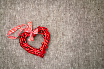 Red straw heart on a grey background