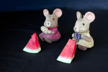 Two mice eating watermelon