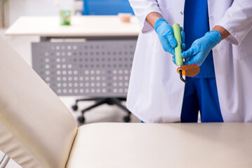 Young male dentist working in the clinic