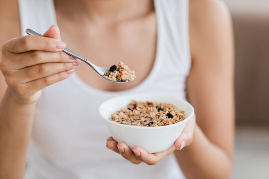 Cropped image of woman holding bowl with homemade granola