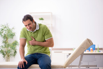 Young male patient waiting for doctor in the hospital