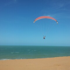 Paraglider over the sea in Fortaleza, Brazil