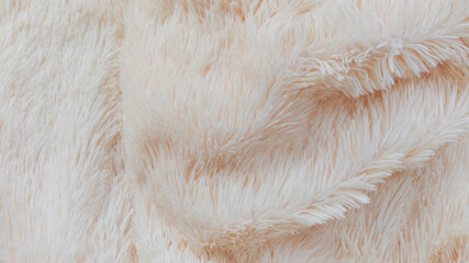 delicate soft background of plush fabric folds on white background. Copy space. Flat lay. loose folds on the fabric of faux fur of lilac color. Details of warm winter clothes