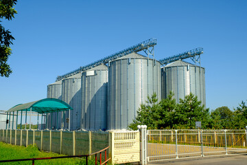 Fototapeta premium Agricultural Silos. Building for storage and drying of grain crops. Agribusiness concept.