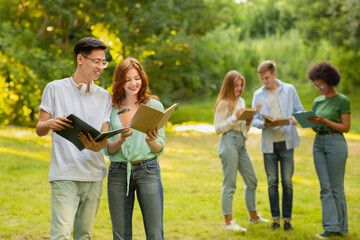 College Life. Cheerful Multiracial Couple Of Students Resting During Break In Campus