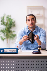 Young man in courthouse in divorcing concept