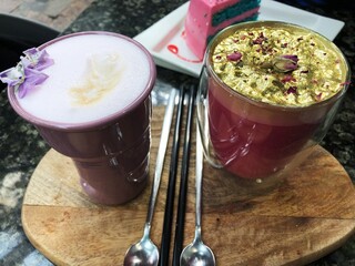 Beautiful coffee with violets and roses in the cafe