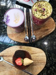 Beautiful coffee with violets and roses in the cafe