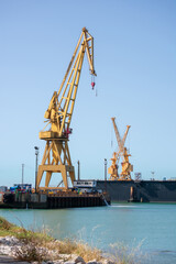 Obraz premium Cranes to repair boats in the bay of Cadiz capital, Andalusia. Spain. Europe. July 01, 2020 