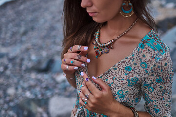 Bohemian chic gypsy woman with manicure wearing jewelry accessories and dress. Boho detail close up © Goffkein