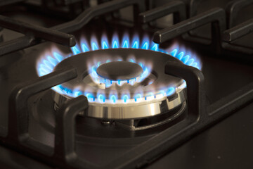 Natural gas burning by blue flames in kitchen stove. Gasification concept.
