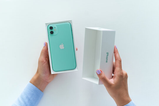 Batumi, Georgia. 27 July 2020 - Unpacking box of mint green iPhone 11 with dual camera of 2019 release. Apple gadgets
