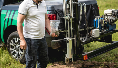 Soil examination. Collecting black soil on the field for examination