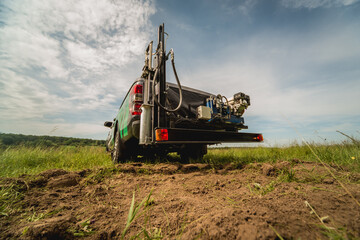 Naklejka premium Soil examination. Collecting black soil on the field for examination
