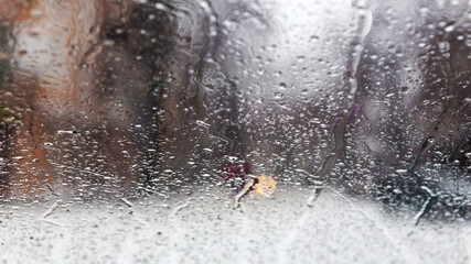 Drops Of Rain On Glass Background. Street Bokeh Lights Out Of Focus. Abstract Backdrop