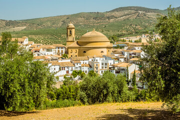Fototapeta na wymiar A view of the church and town of Montefrio, Spain in the summertime
