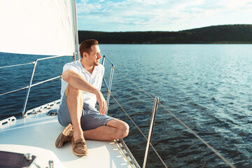 Man Relaxing Sitting On Sailboat Deck Spending Summer Day Outside