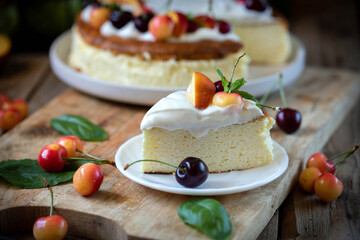 Cheesecake garnished with whipped cream, cherries and peaches.
