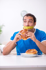 Young hungry man in dieting concept