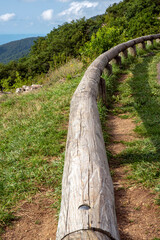 wooden fence along with the hill road	