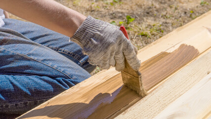 Applying protective varnish on a wooden furniture