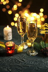 selective focus of glasses full of champagne against christmas lights