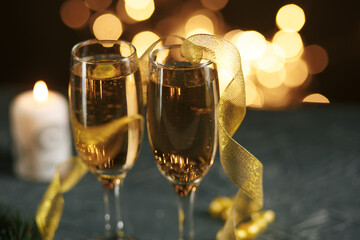 selective focus of glasses full of champagne against christmas lights