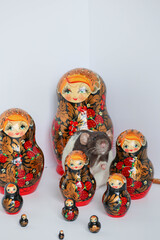 Decorative black and white rat sniffs toys.Many red wooden dolls matryoshka. Traditional Russian...