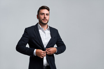 Close up portrait young man businessman. Caucasian guy business suit studio gray background.