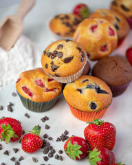 Cupcakes with fruit and chocolate on a marble background