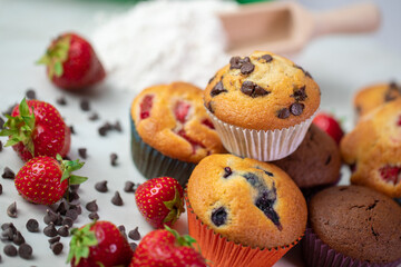 Cupcakes with fruit and chocolate on a marble background