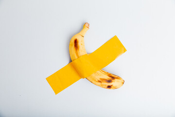 Taped banana on the wall as an art object. Minimalism concept