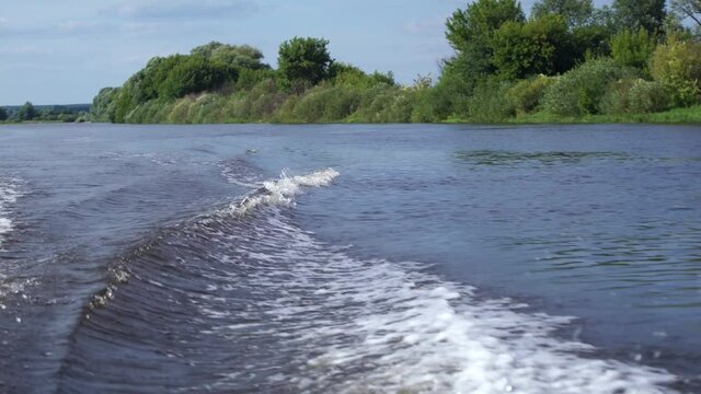 4k video footage of motor boat water traces blue river. 