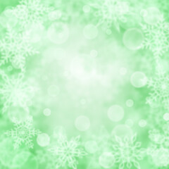 Fototapeta na wymiar Christmas background of blurry snowflakes in green colors