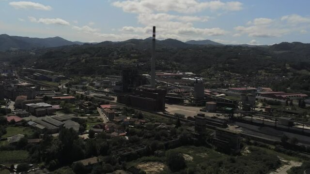 Chimney of chemical factory in Langreo, village of Asturias,Spain. Aerial Drone Footage