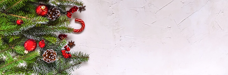 Christmas white grunge background, top view, decorated with fir twigs, berries, baubles. Christmas, New Year decoration, pine tree branches and cones on light background, flat lay, copy space.