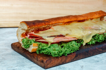 ham and cheese sandwich on a wooden board