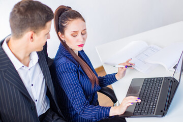 Sexual harassment at work. The man sat down to a female colleague on a chair and hugs her. Office...