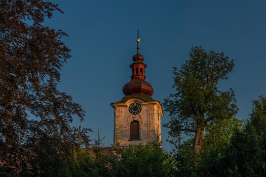 Church and castle in Petrovice village in central Bohemia in summer evening