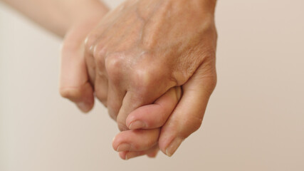 Old and young hand holding together. Close up shot. High quality photo