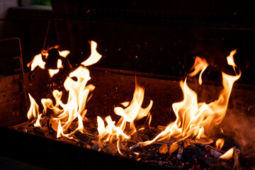 smoulder charcoal texture.Barbecue Flaming Charcoal Grill With Bright Flames Of Fire.Selective focus. burning wood and coal