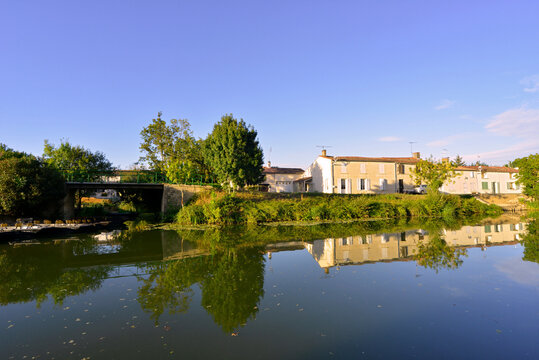 Barques et reflets des maisons sur la S&egrave;vre Niortaise &agrave; Damvix (85420), Vend&eacute;e en Pays de la Loire, France