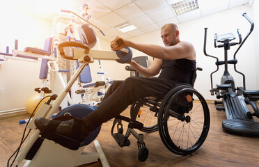 Disabled man training in the gym. Rehabilitation center